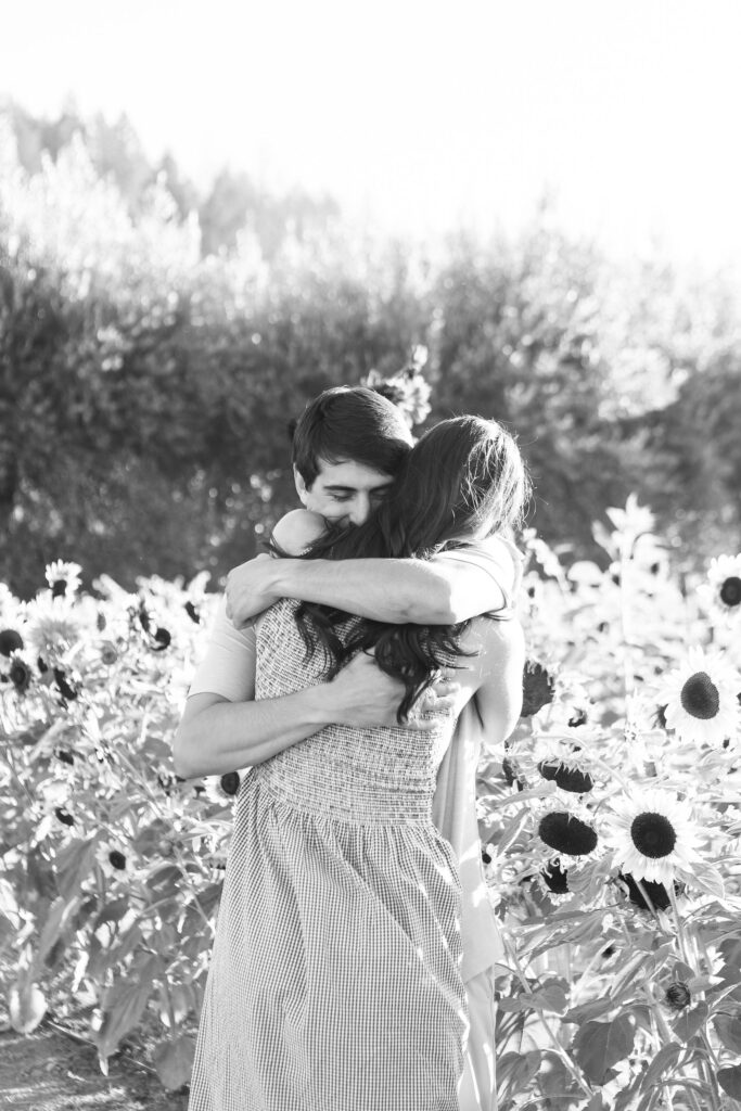 A couple embracing one another in a sunflower field in St. Helena